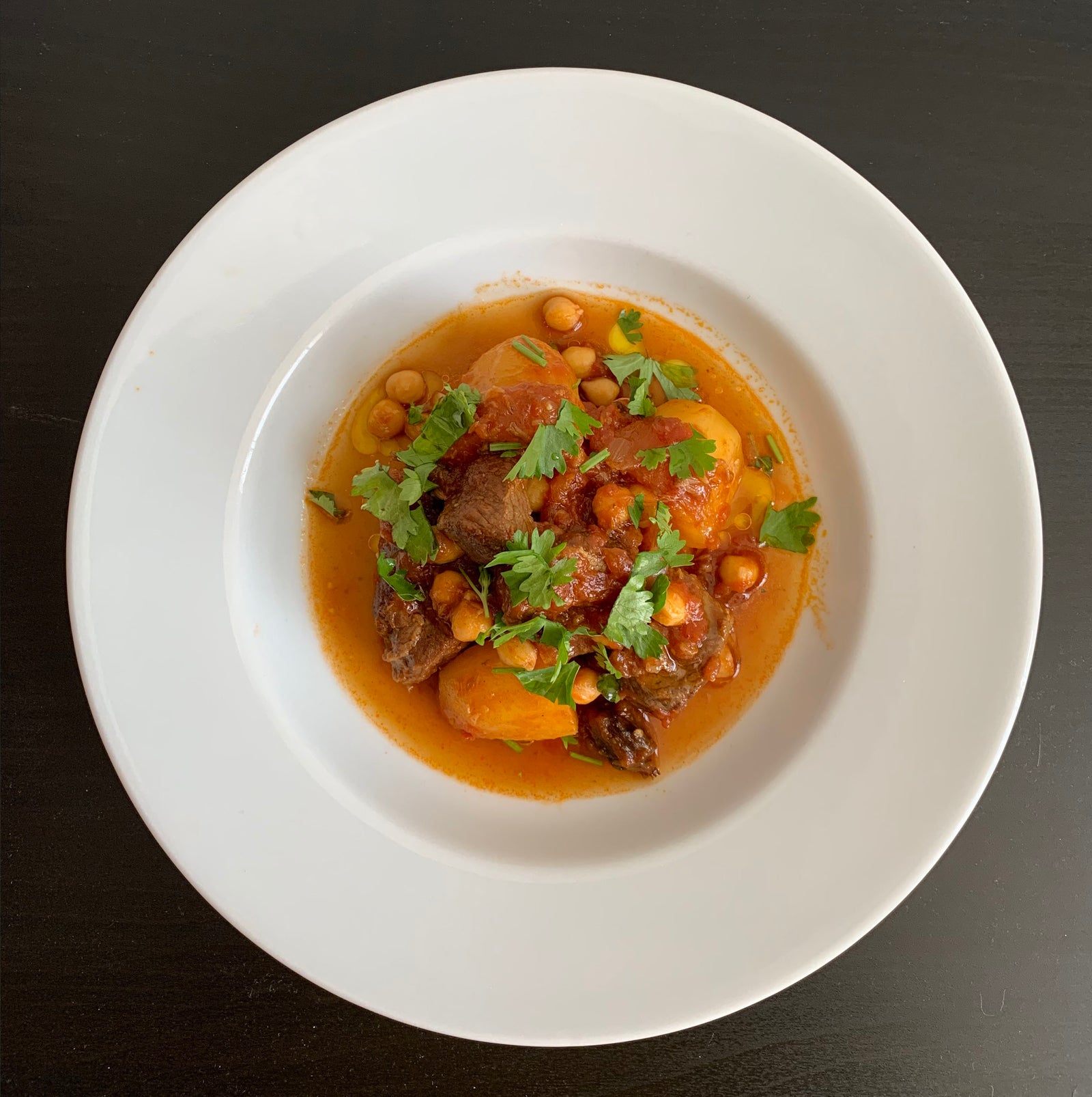 An image of lamb, chickpeas, and potatoes.